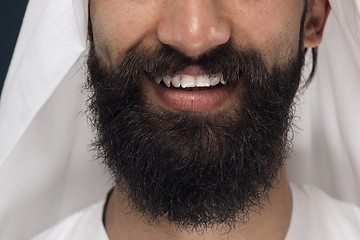 Image showing Arabian saudi man on dark blue studio background