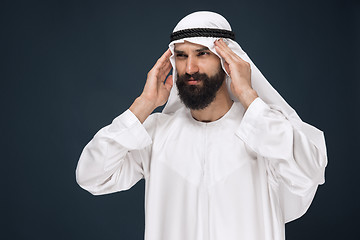 Image showing Arabian saudi man on dark blue studio background