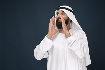 Image showing Arabian saudi man on dark blue studio background