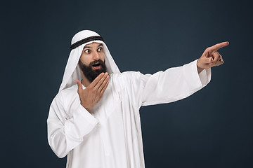 Image showing Arabian saudi businessman on dark blue studio background