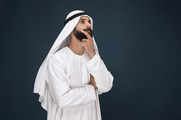 Image showing Arabian saudi businessman on dark blue studio background