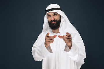 Image showing Arabian saudi businessman on dark blue studio background