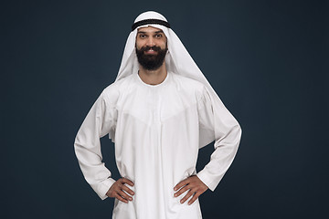 Image showing Arabian saudi businessman on dark blue studio background