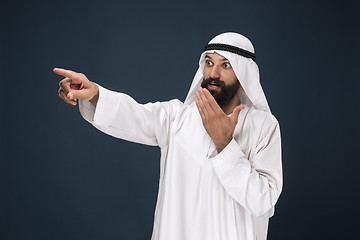 Image showing Arabian saudi businessman on dark blue studio background