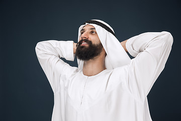 Image showing Arabian saudi businessman on dark blue studio background