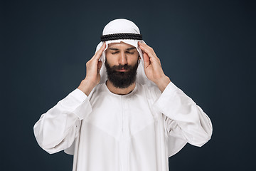 Image showing Arabian saudi man on dark blue studio background