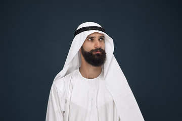 Image showing Arabian saudi businessman on dark blue studio background