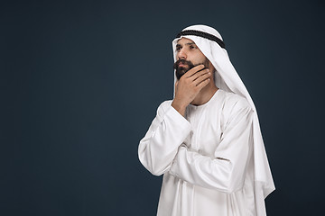 Image showing Arabian saudi businessman on dark blue studio background