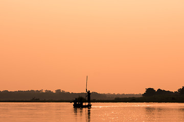 Image showing Men in a boat on a river silhouette