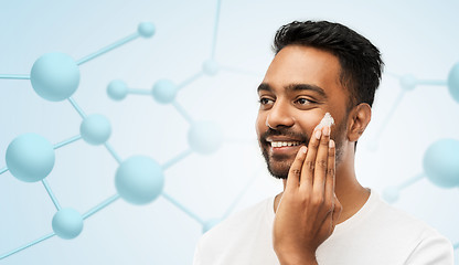 Image showing indian man applying cream to face gel