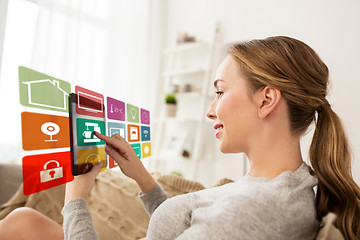 Image showing woman with tablet computer and smart home icons