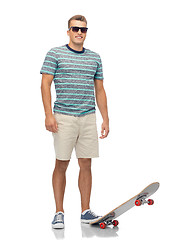 Image showing smiling young man with skateboard over white