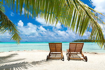 Image showing tropical beach with palm tree and sunbeds