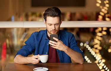 Image showing man with coffee and smartphone at restaurant