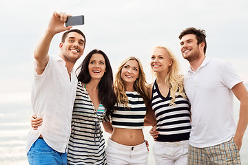 Image showing happy friends taking selfie on summer beach