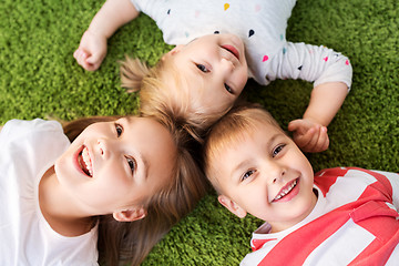 Image showing happy little kids lying on floor or carpet