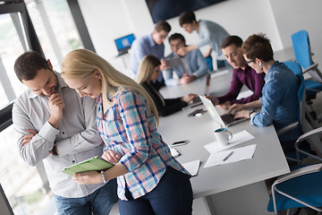 Image showing Two Business People Working With Tablet in office