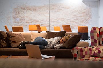 Image showing woman sleeping on a sofa  in a creative office