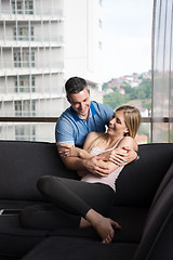 Image showing young handsome couple hugging on the sofa