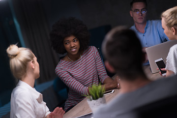 Image showing Multiethnic startup business team in night office