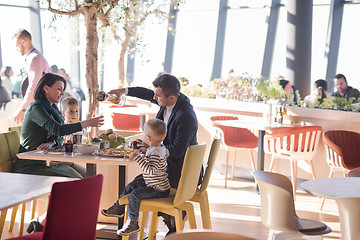 Image showing Young parents enjoying lunch time with their children