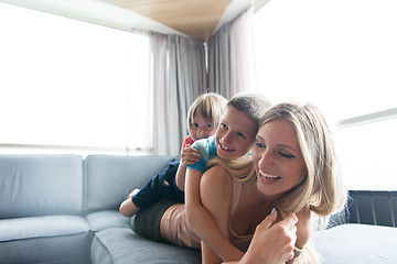 Image showing young mother spending time with kids on the floor