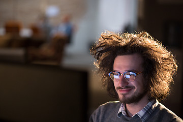 Image showing man working on computer in dark office