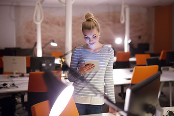 Image showing woman working on digital tablet in night office