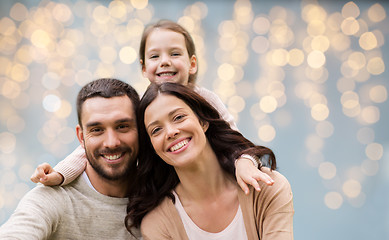 Image showing happy family over festive lights background