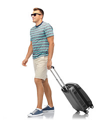 Image showing man in sunglasses with travel bag