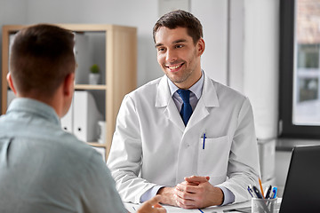 Image showing smiling doctor talking to male patient at hospital