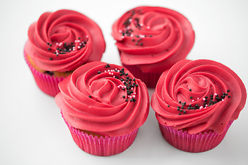 Image showing close up of cupcakes with red buttercream frosting