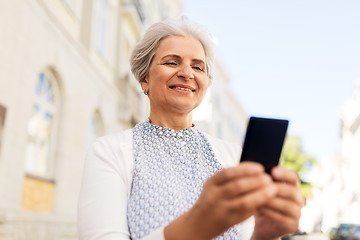 Image showing happy senior woman with smartphone in summer