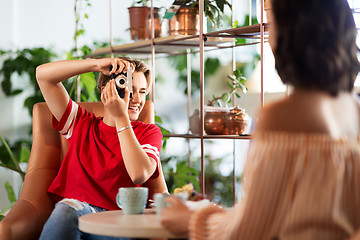 Image showing women drinking coffee and photographing at cafe