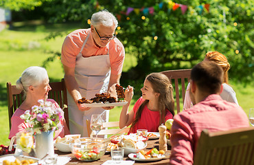 Image showing family having dinner or barbecue at summer garden