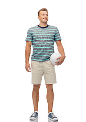 Image showing smiling young man with volleyball