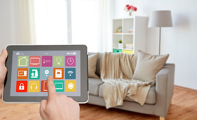 Image showing hands with smart home icons on tablet computer