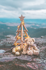 Image showing Christmas tree with golden star lights against mountain backdrop