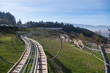 Image showing couple enjoys driving on alpine coaster