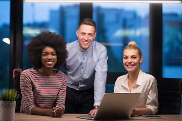 Image showing Multiethnic startup business team in night office