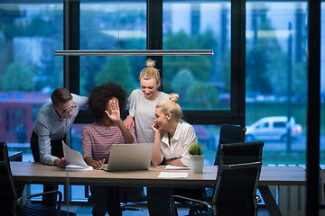 Image showing Multiethnic startup business team in night office