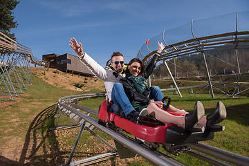 Image showing couple enjoys driving on alpine coaster