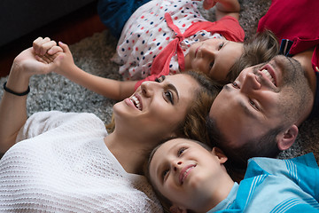 Image showing happy family lying on the floor