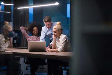 Image showing Multiethnic startup business team in night office