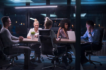 Image showing Multiethnic startup business team in night office