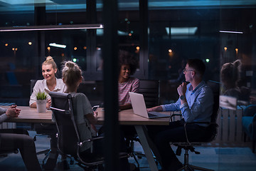 Image showing Multiethnic startup business team in night office