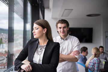 Image showing Elegant Woman Using Mobile Phone by window in office building