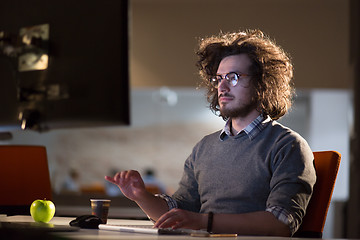 Image showing Tired businessman working late