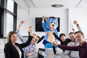 Image showing boss dresed as bear having fun with business people in trendy of