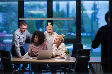 Image showing Multiethnic startup business team in night office